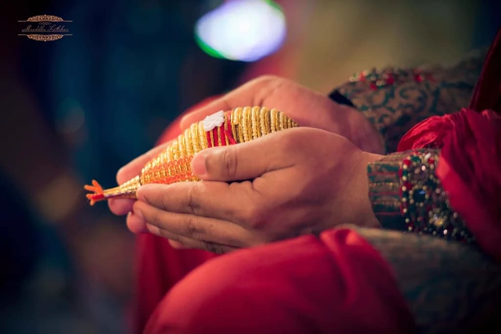 A couple holding hands during a ring ceremony